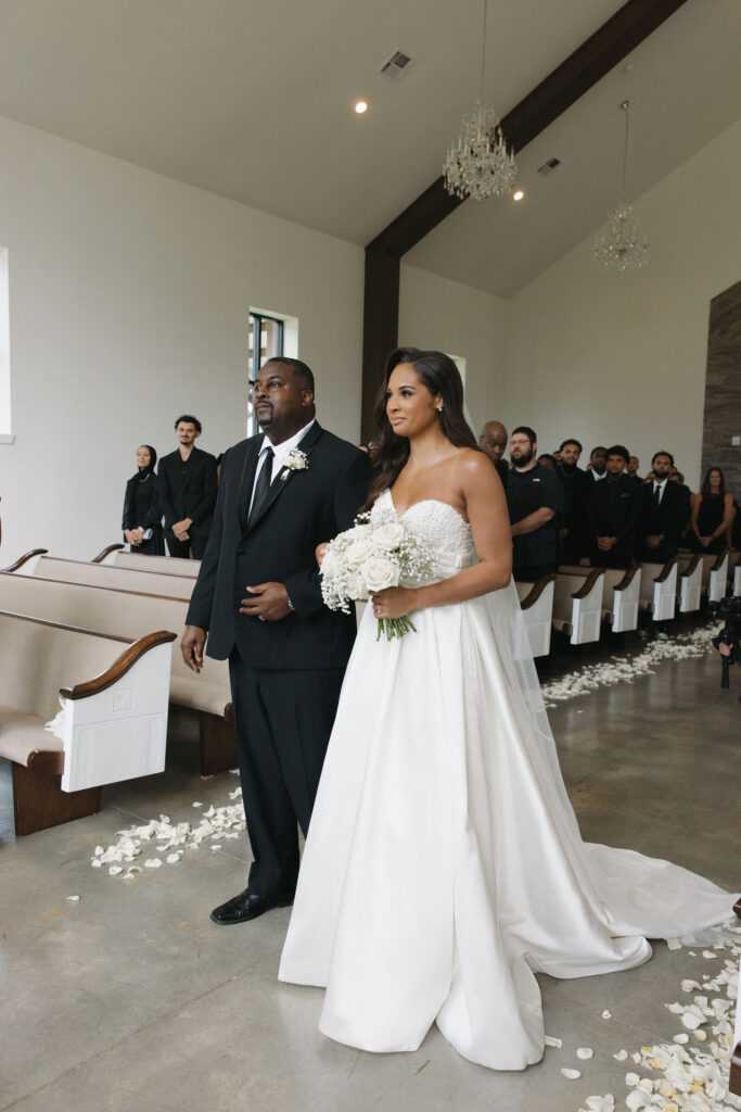 bride walking down the aisle with her dad