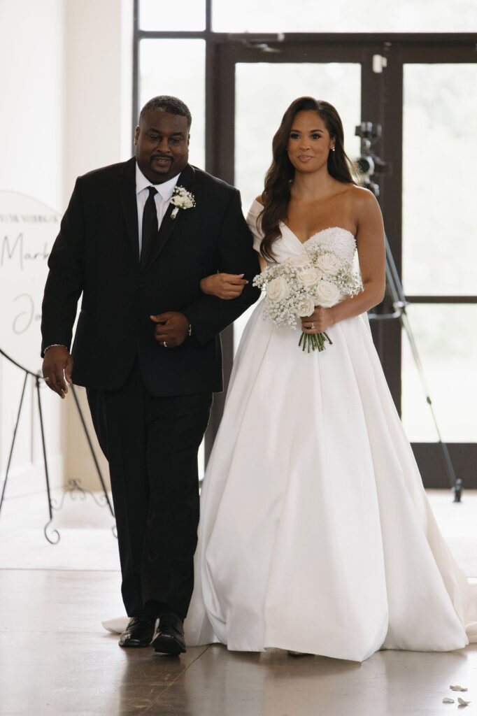 bride walking down the aisle with her dad