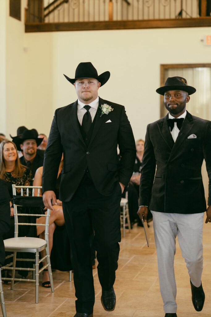 Groom walking down the aisle with the officiant before his wedding ceremony