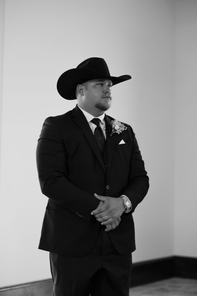 groom watching his bride walk down the aisle