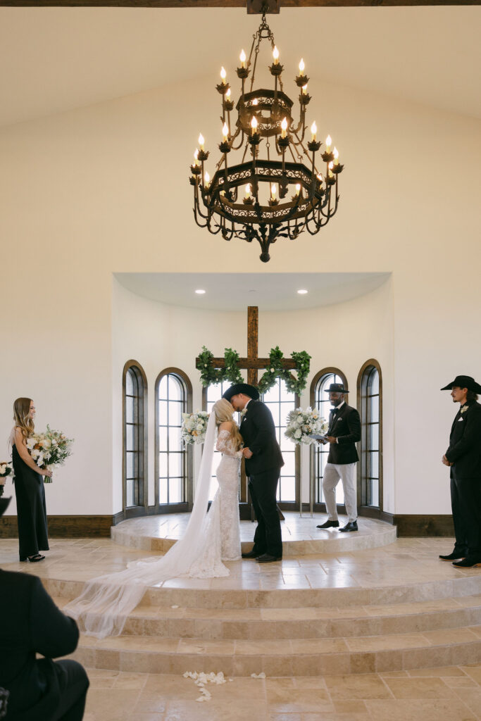 Bride and groom during their wedding ceremony at The Chapel at Palacios