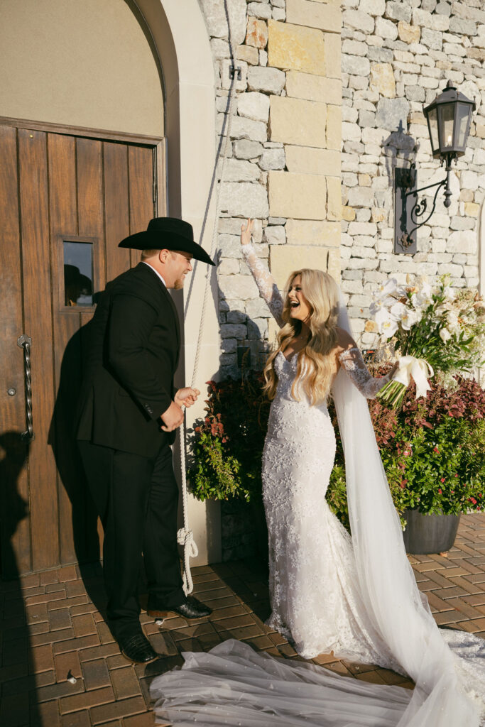 Bride and groom ringing the chapel bell after getting married at The Chapel at Palacios