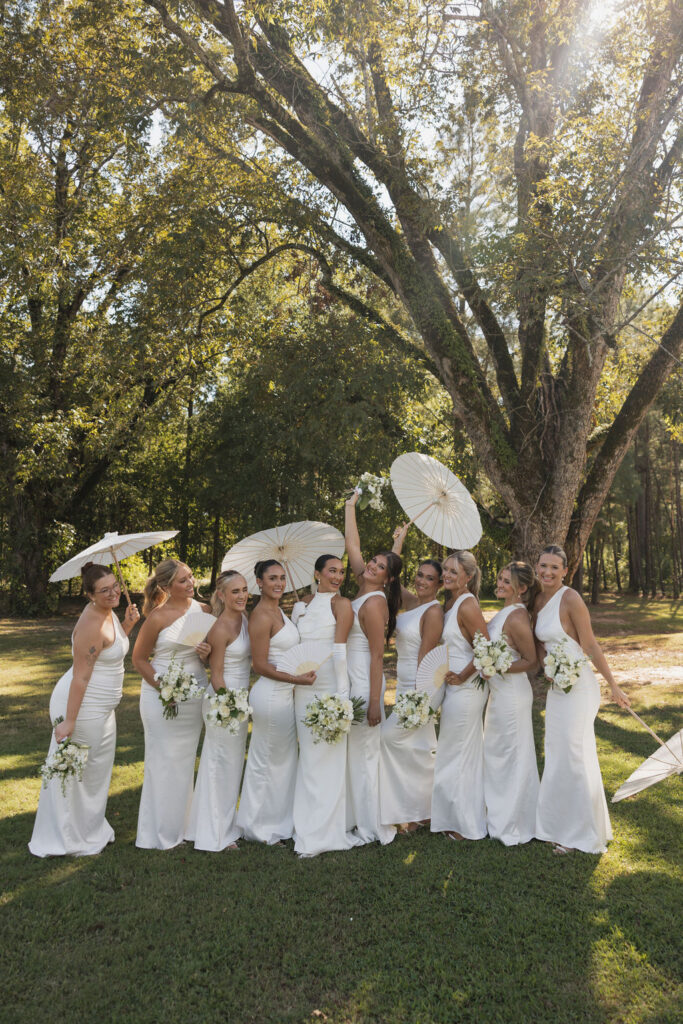 bride with her bridesmaids all wearing white dresses