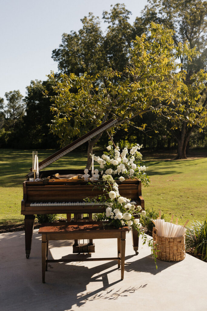 a brown piano with white flowers on it for a wedding in East Texas