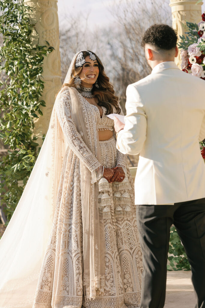 A groom reading his vows to his bride during their wedding ceremony at D'Vine Grace Vineyard