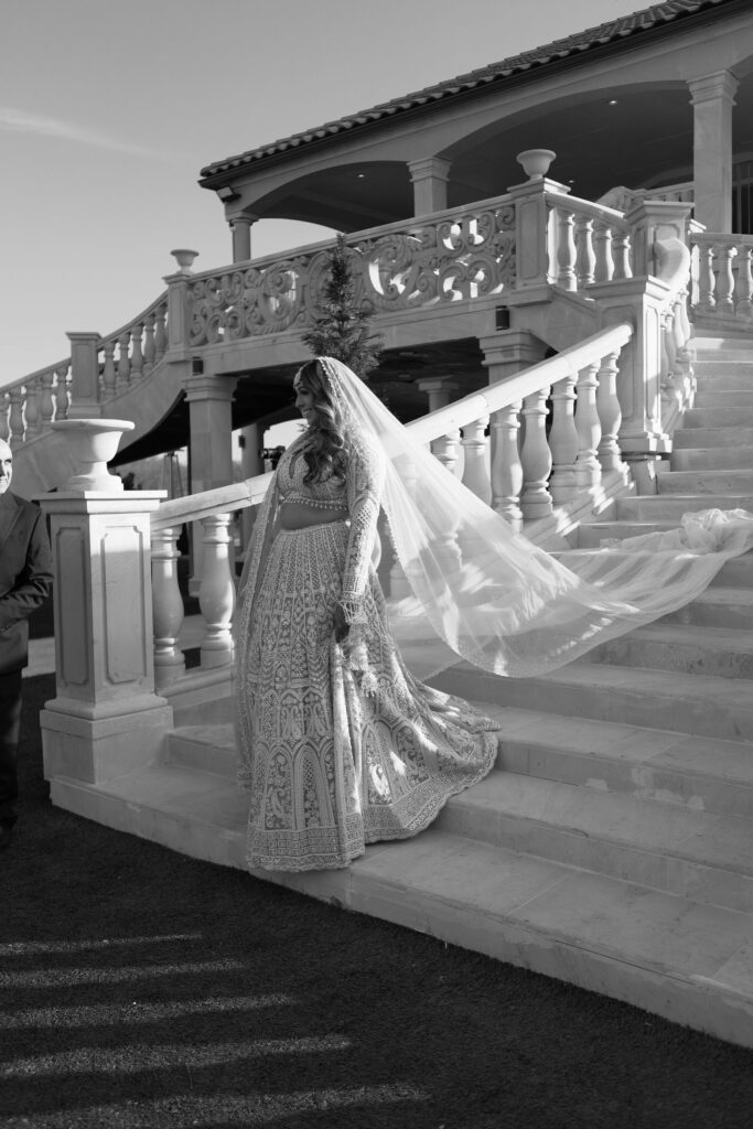 A bride walking down the stairs to her wedding ceremony