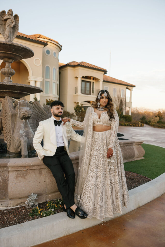 A bride and groom in front of D'Vine Grace Vineyard, bride is wearing traditional Indian bridal attire