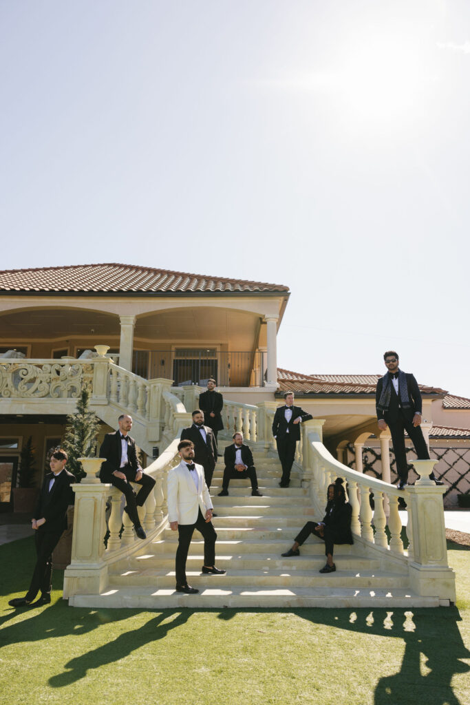 An editorial shot of a groom with his grooms men on the stairs at D'Vine Grace Vineyard