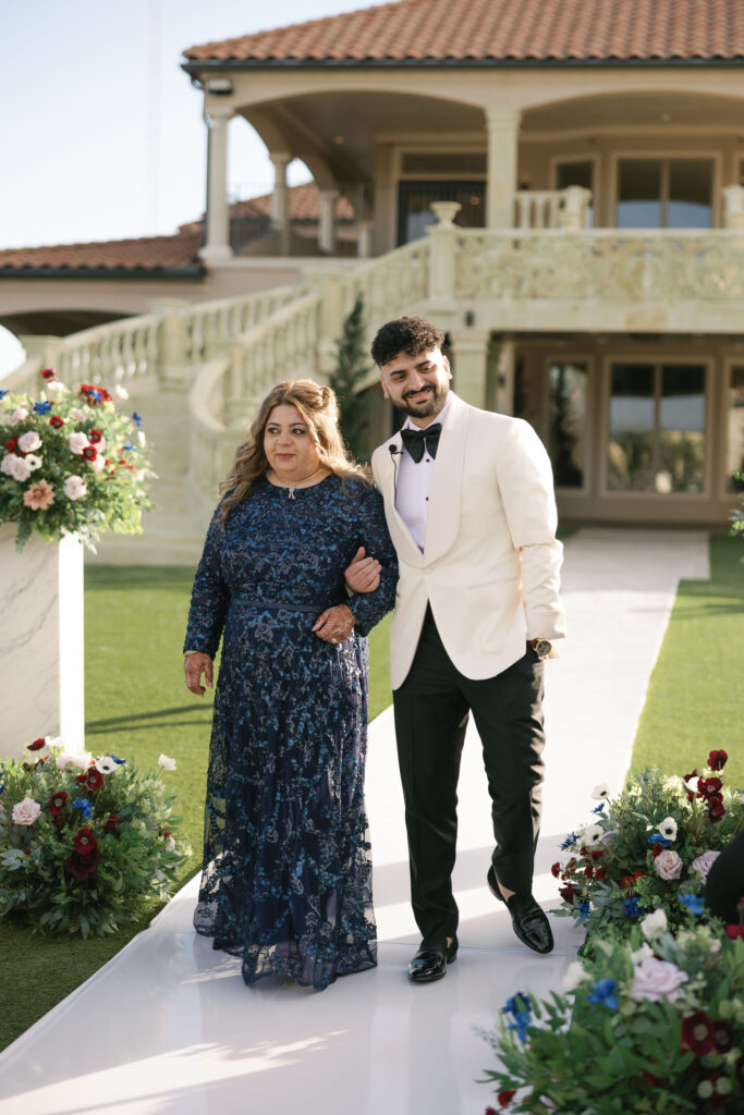 The groom walking his mom down the aisle