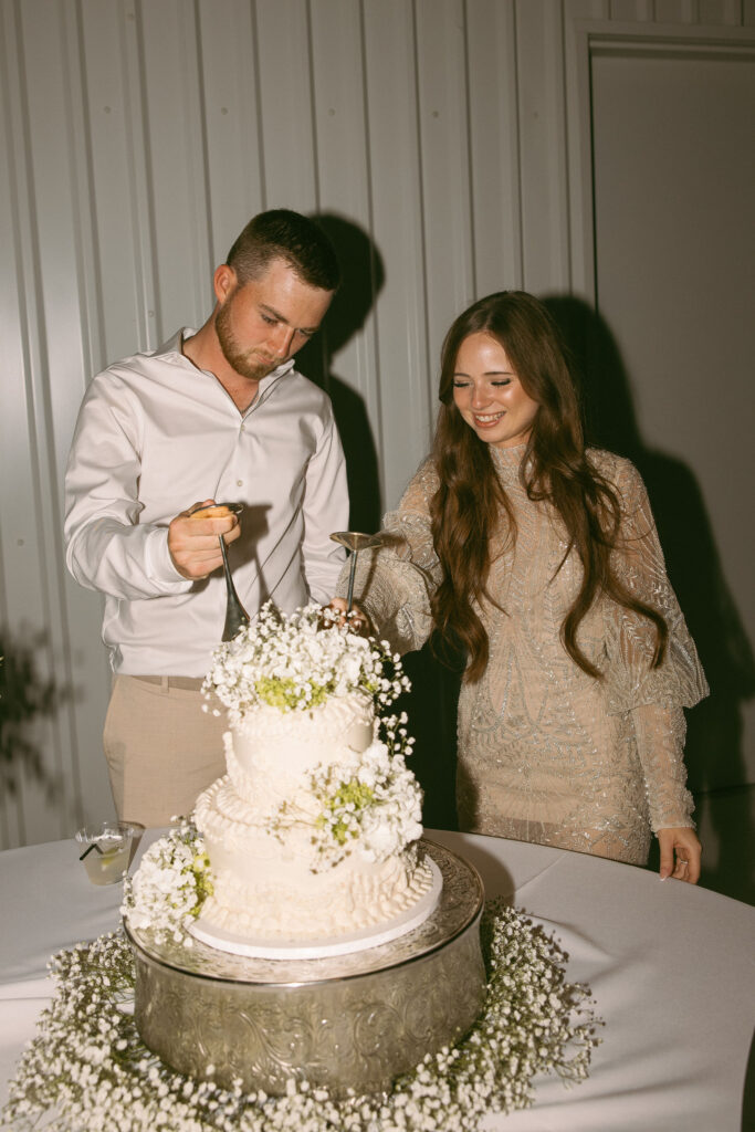 bride and groom cutting the cake