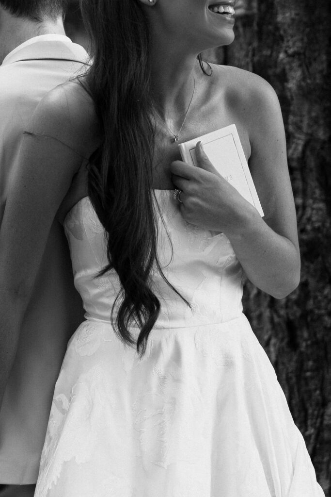 bride with vow book on 4th of july wedding