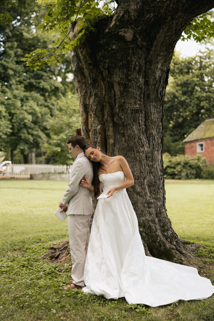 bride leaning on groom in front of tree in nashville