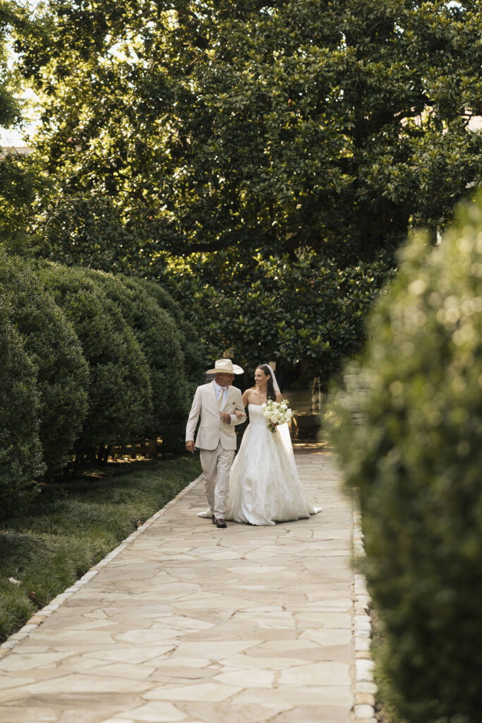 bride walking down isle with father
