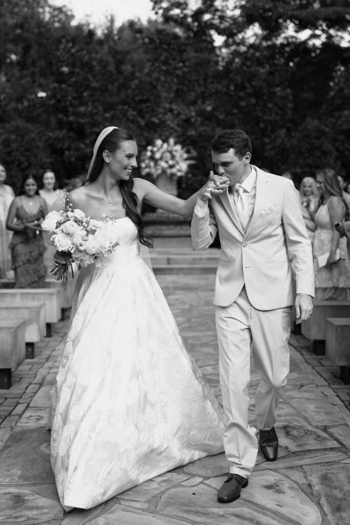 4th of july wedding in nashville groom kissing brides hand