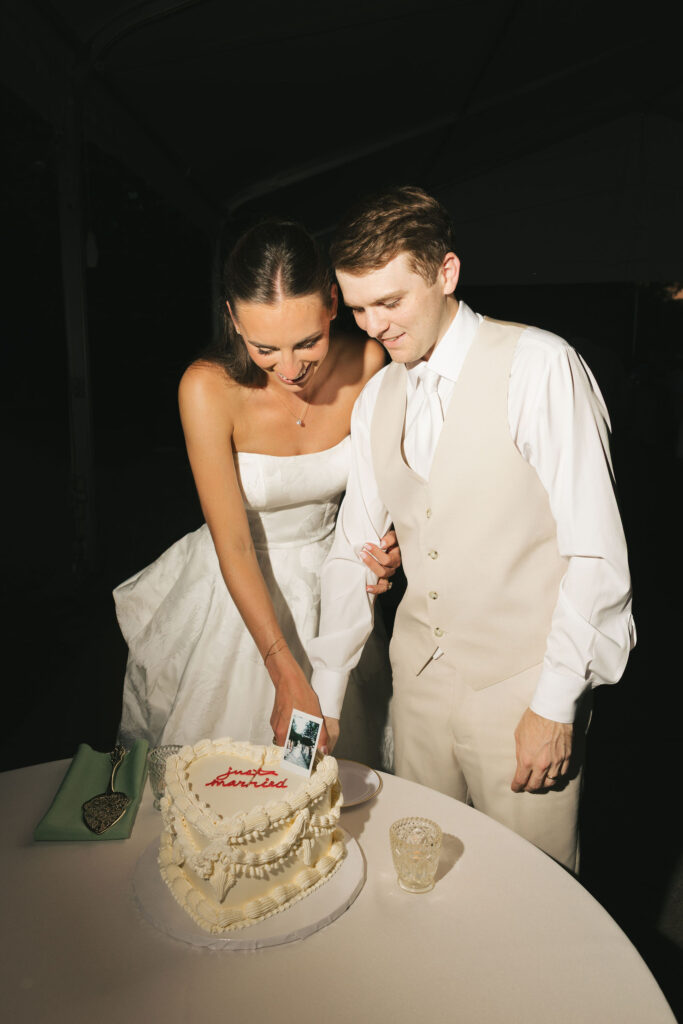 bride and groom in nashville cutting cake