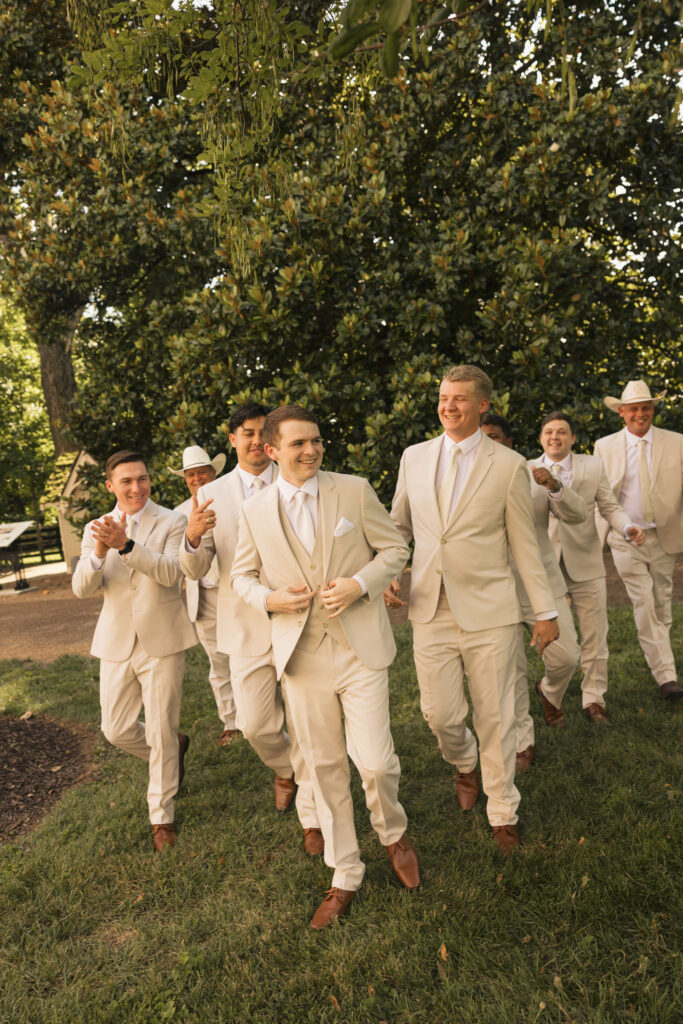 broom with friends walking in tan suits