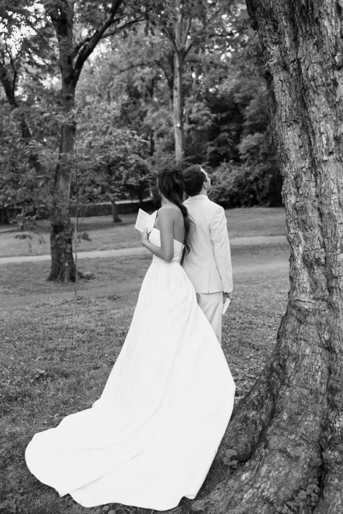 bride and groom saying vows by tree