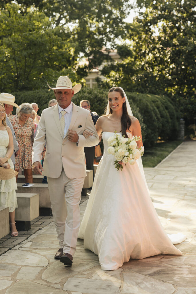 bride walking down isle with father on 4th of july at wedding