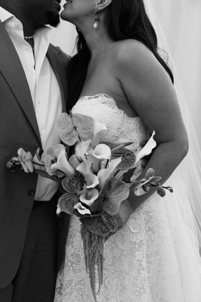 black and white wedding photo with tropical flowers