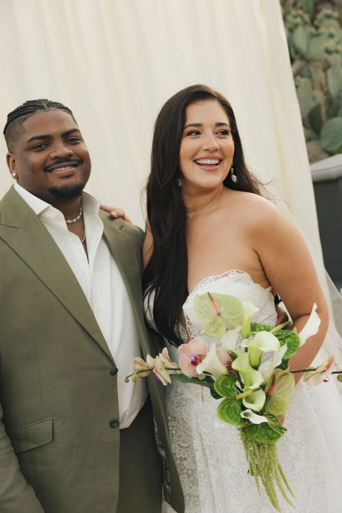 bride and groom in california with tropical flowers