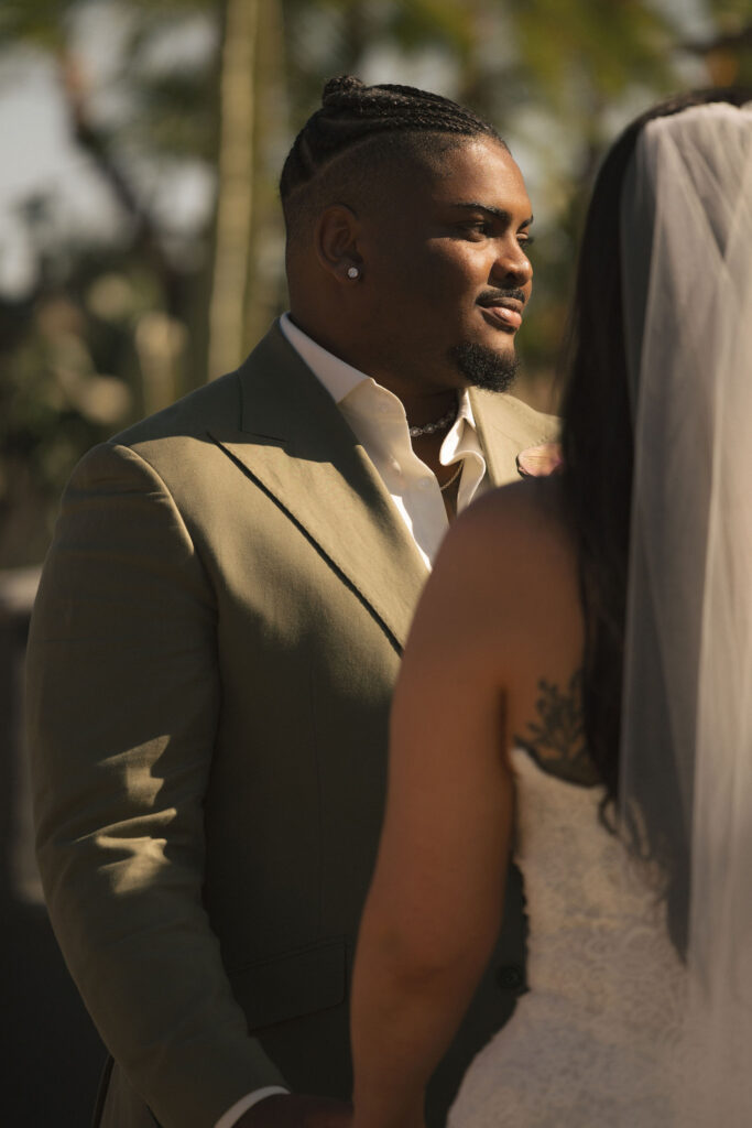 groom at wedding in green suit