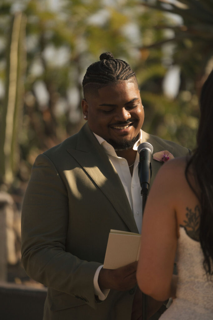 groom laughing during vows in california