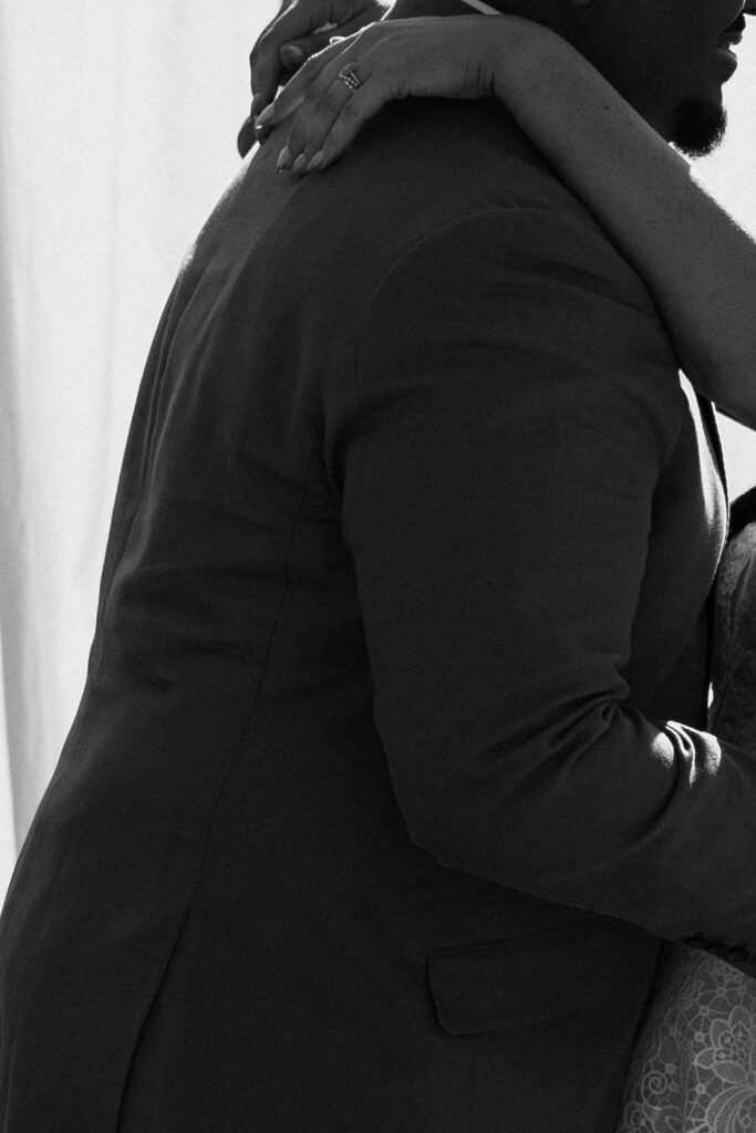 close up of groom hugging bride