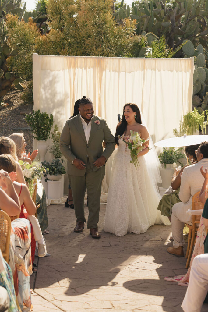 bride and groom walking down the isle at wedding in san diego