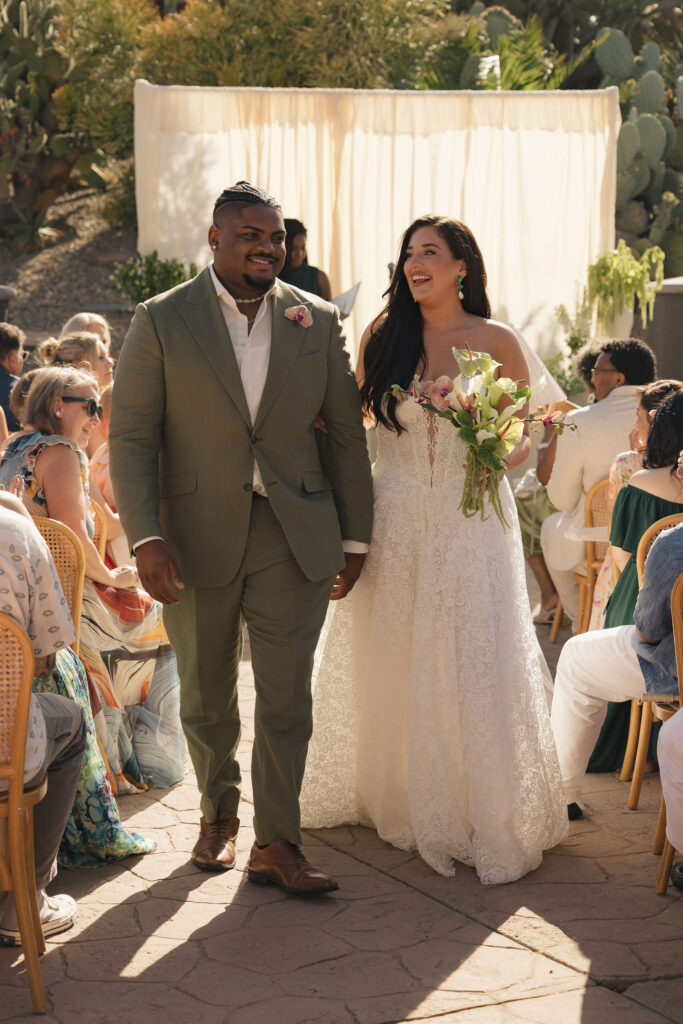 bride and groom walking down the isle at wedding in california
