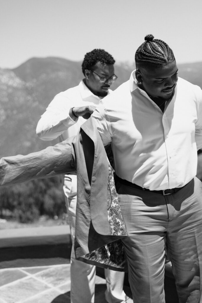 groom getting ready for wedding with friends
