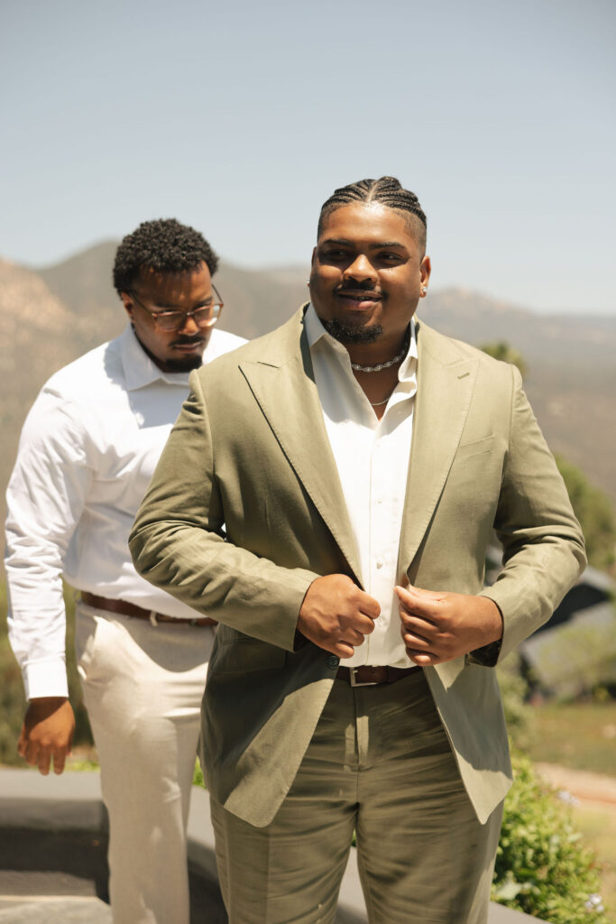 groom in green suit in california