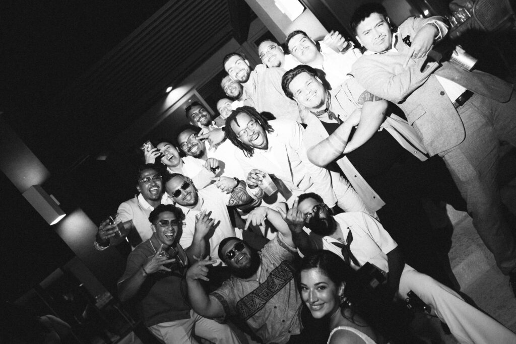 black and white image of friends partying at wedding