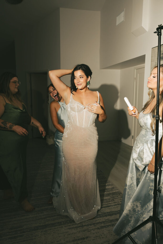 bride getting ready for reception in beaded dress