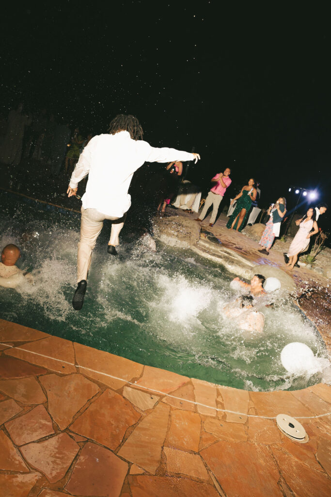 wedding guest jumping in pool in san diego