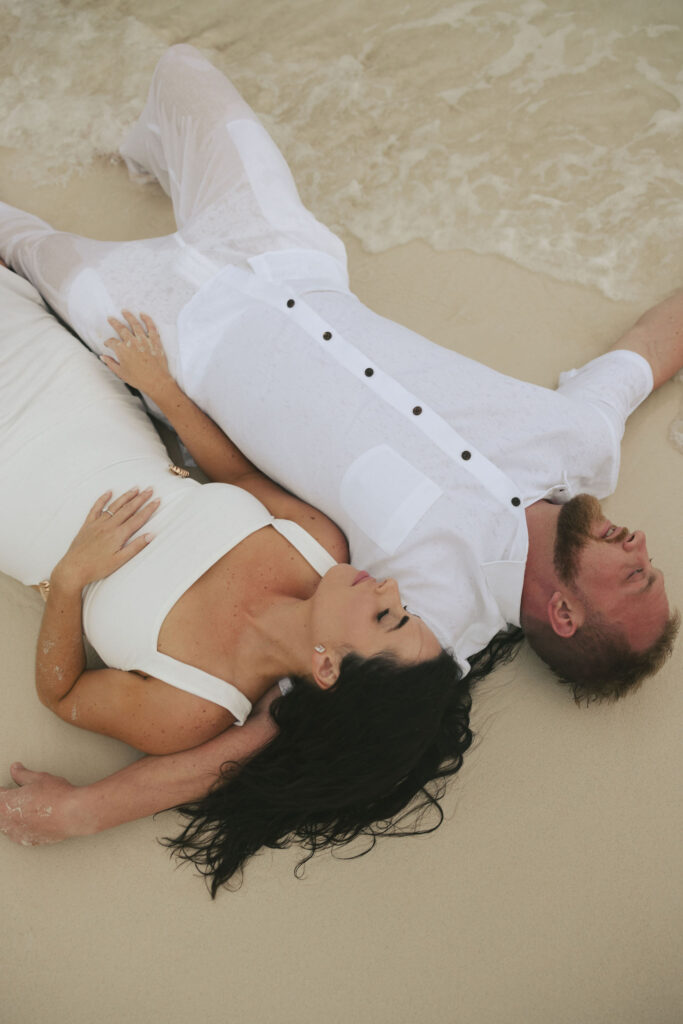 couple laying in sand