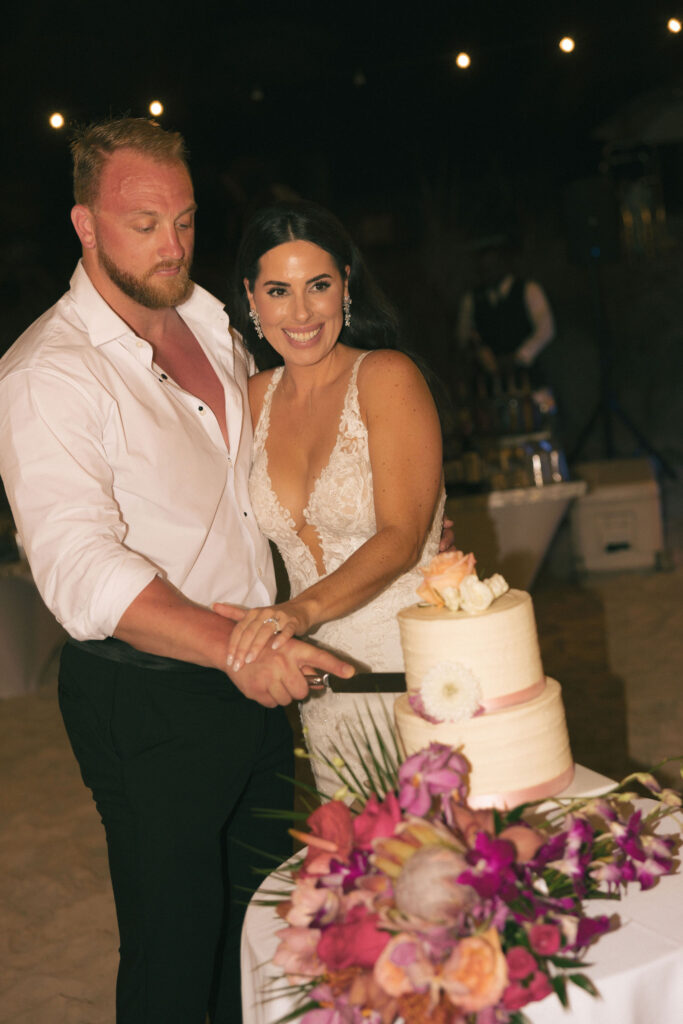 bride and groom cut cake