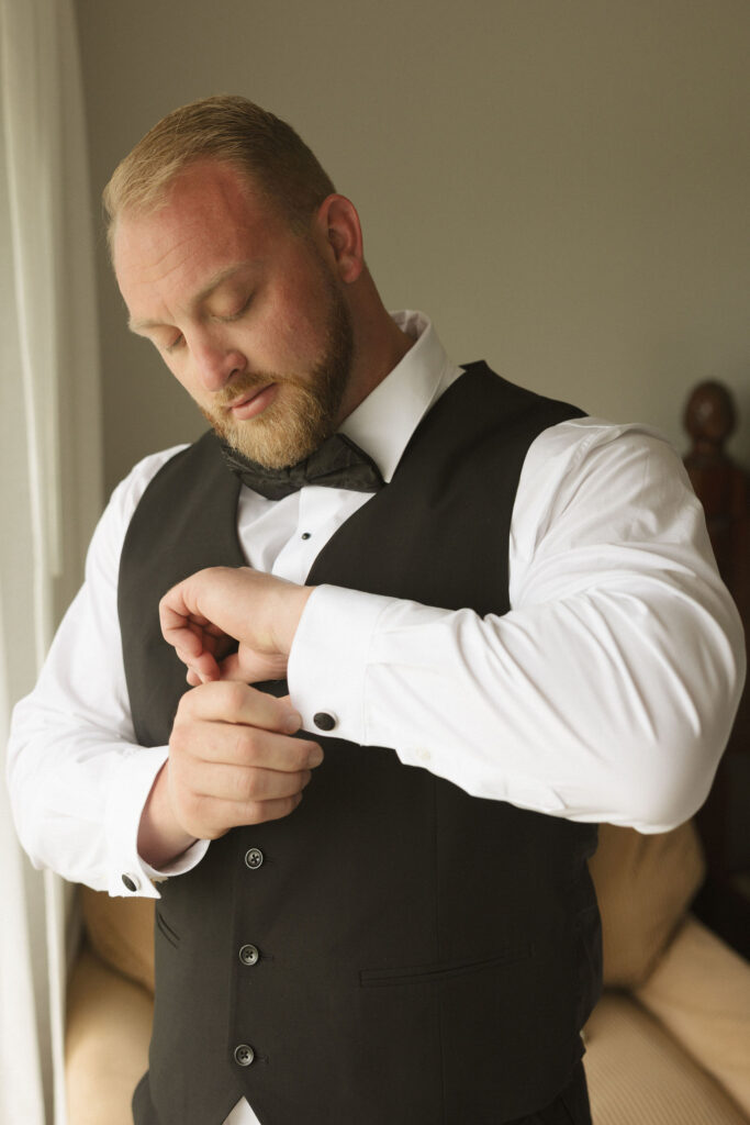 groom buttoning cufflink