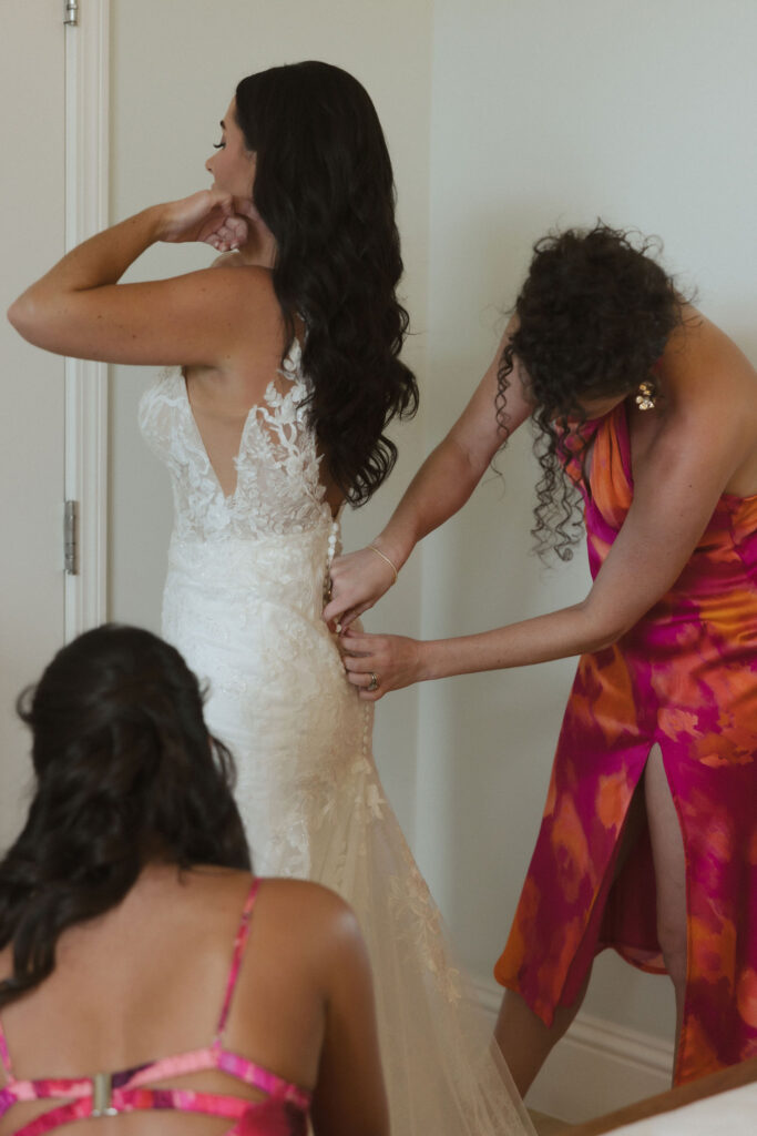 bridesmaids helping bride