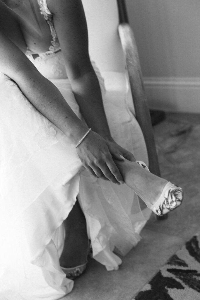 bride putting on shoes for Turks and Caicos Wedding