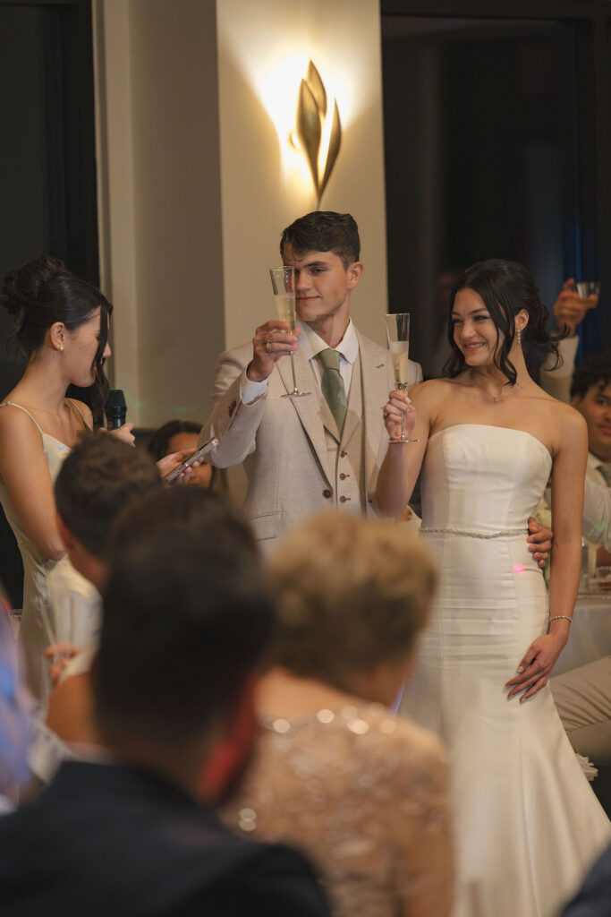 bride and groom toast at wedding