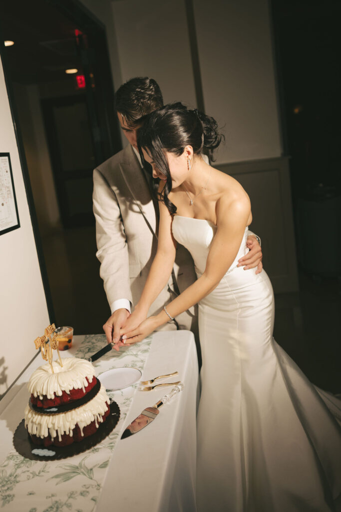 bride cutting wedding cake