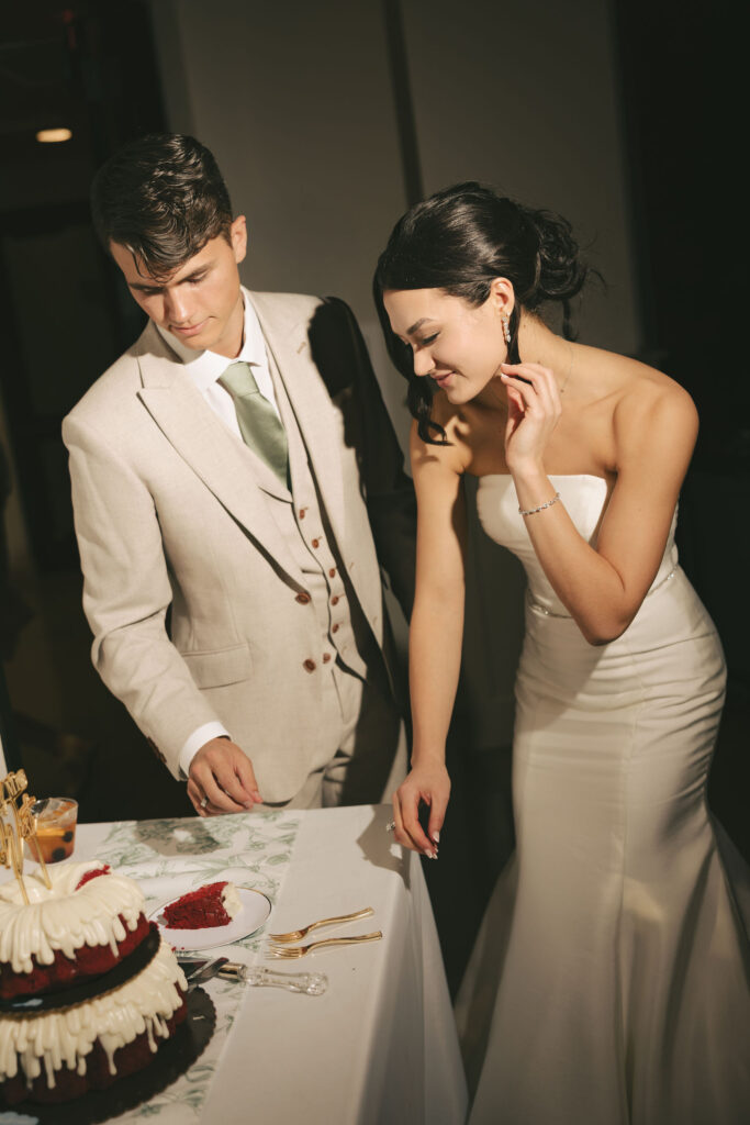 bride and groom cutting cake at greek orthodox wedding