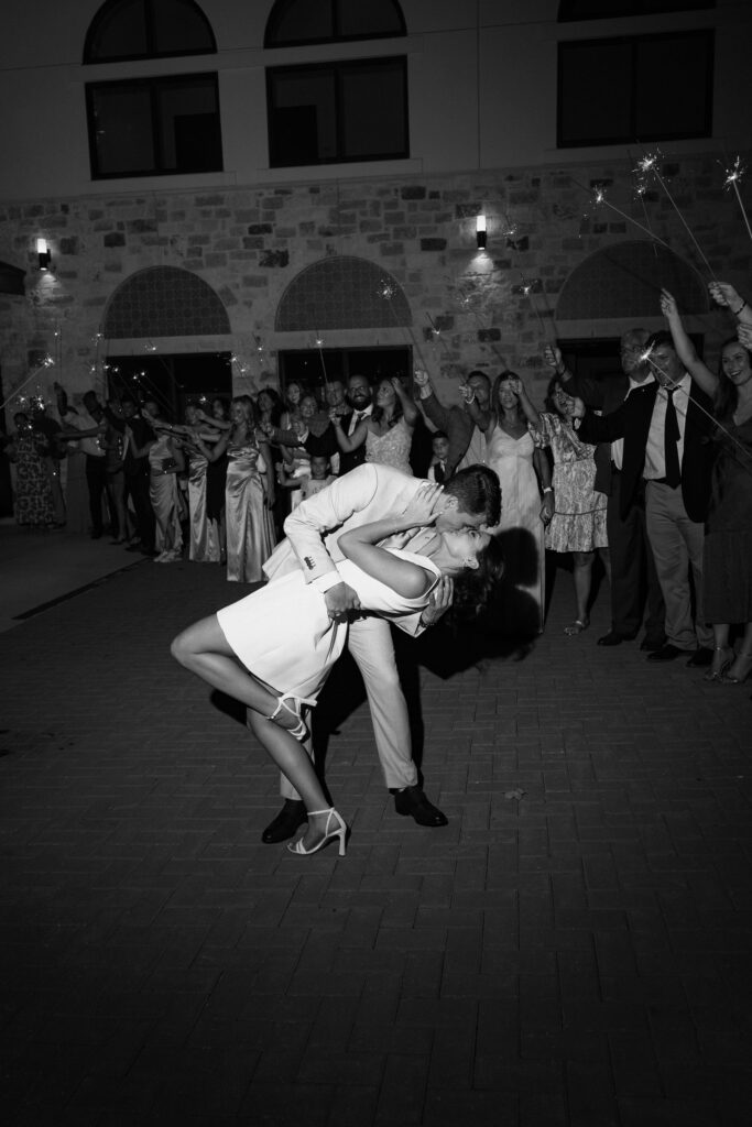 Bride and groom kissing at end of wedding