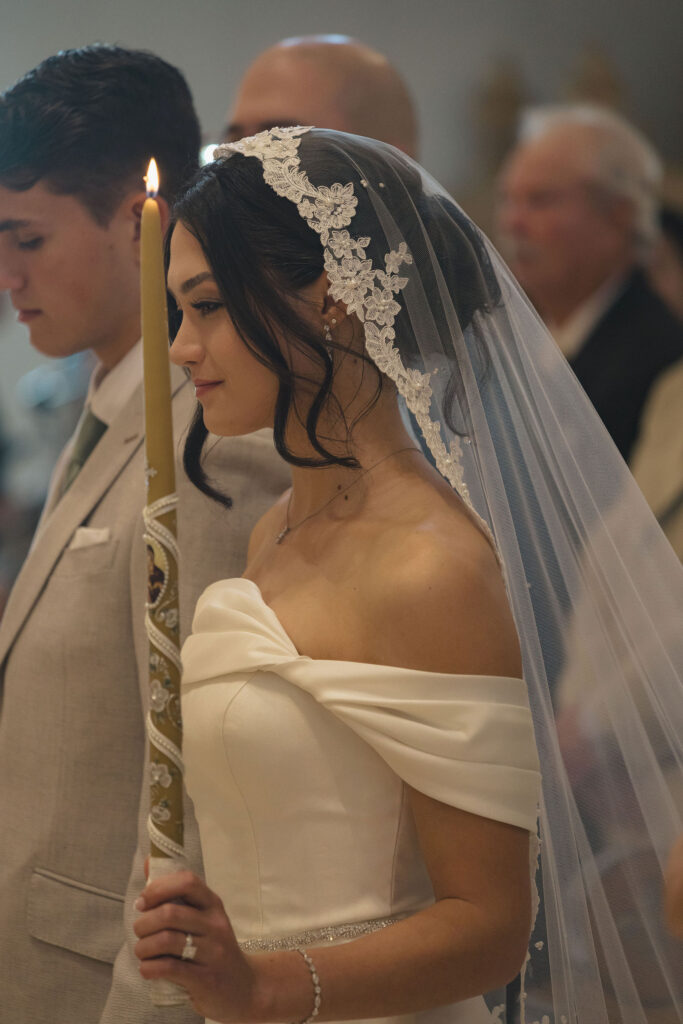 bride in veil with candle
