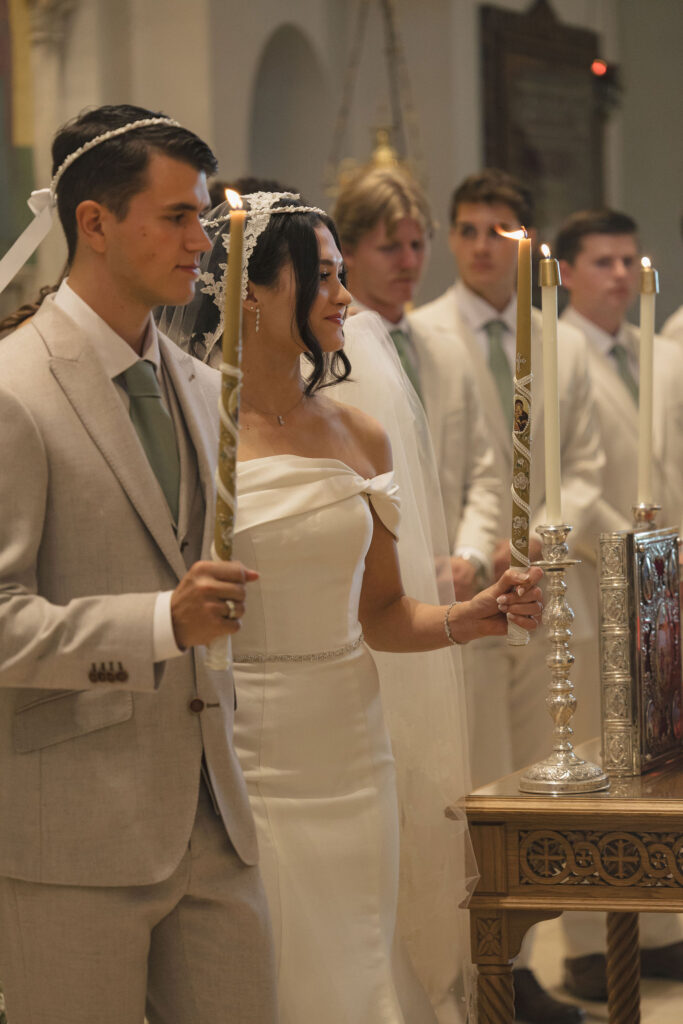 bride and groom with candles and crowns