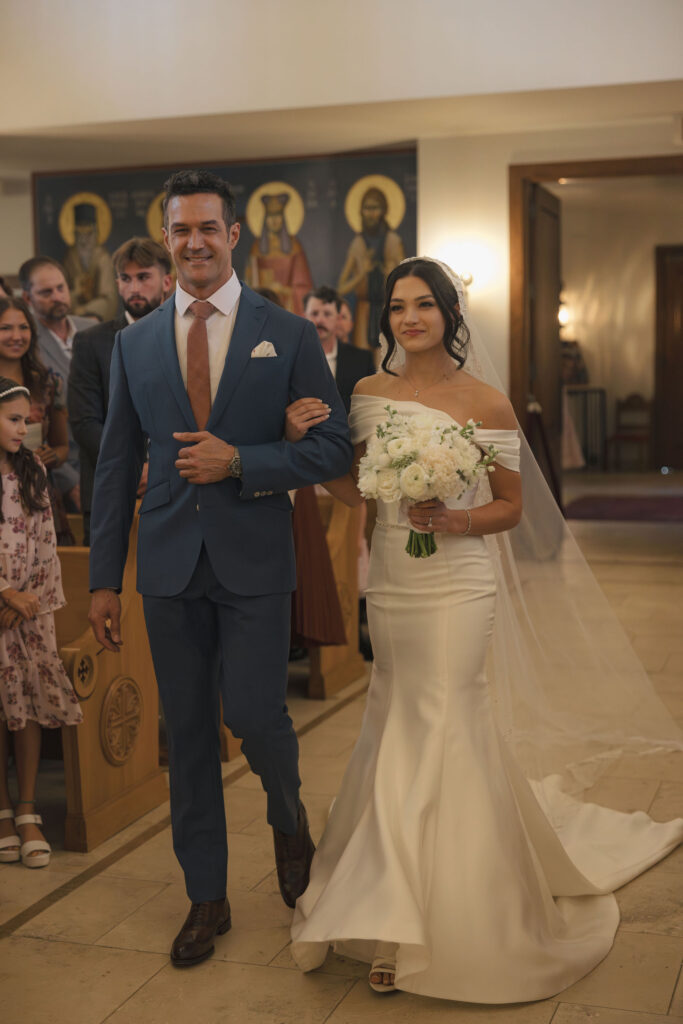 bride walking down the aisle at greek orthodox wedding