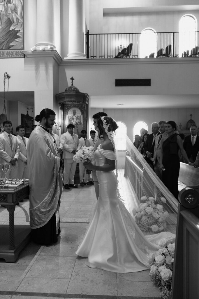 black and white image of bride and groom in church