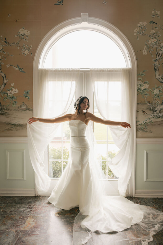bride in front of curtains flowing