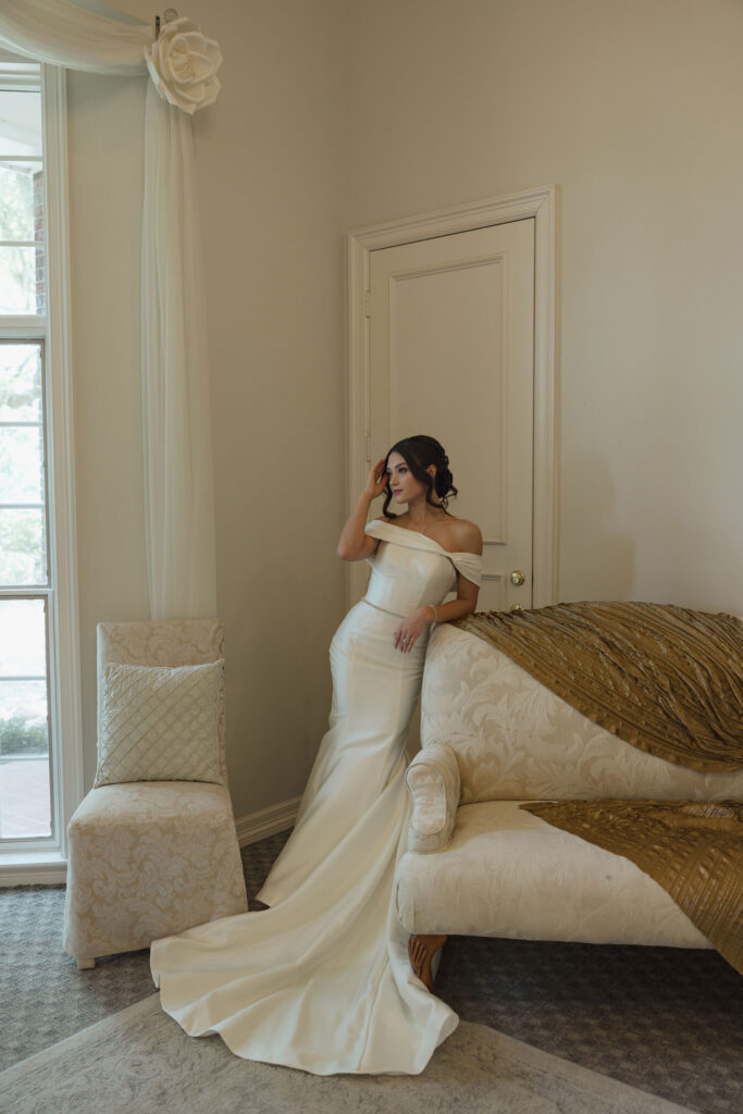bride lounging by couch bridal portrait