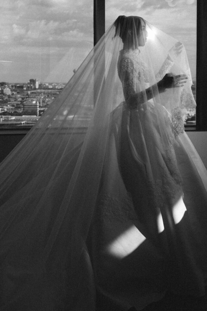 black and white image of bride and Dallas skyline